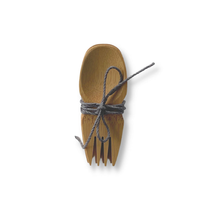 Bamboo spork set of 4, shown stacked with gray natural fiber cord tied around set.