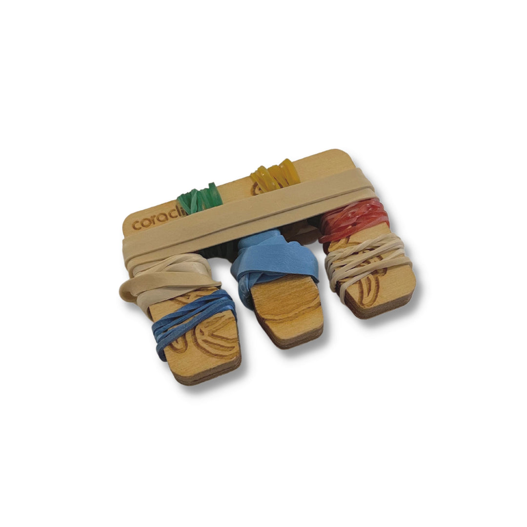 Wooden bag in Crab design, shown with rubber bands, wrapped for storage or portability.