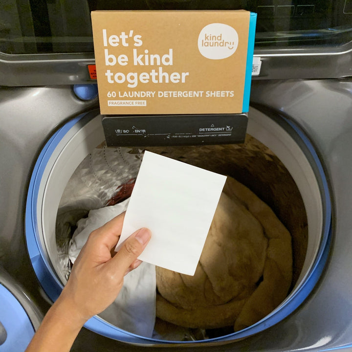 Eco friendly detergent sheet being placed in washing machine.