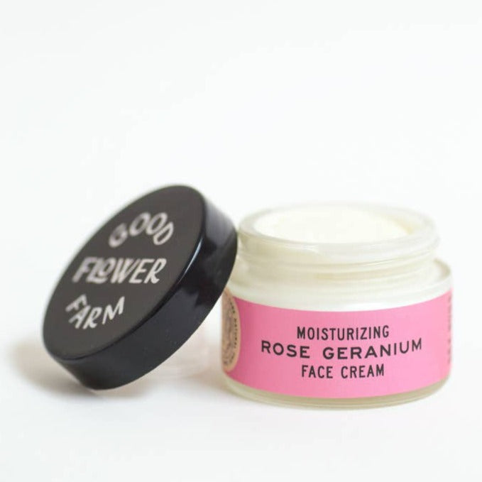 Good Flower Farm Organic Rose Geranium Face Cream In Glass Jar. Open With Lid Resting On Jar.