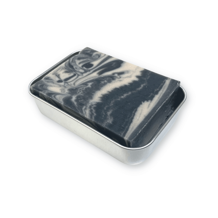 Aluminum Travel Soap Case middle insert with drain holes, shown with Rock Creek Soaps Starry Night Soap Bar for size comparison.
