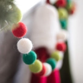 Friendsheep North Pole Eco Garland, in White, Red, Light Green, and Dark Green Colors. Close-up, Hanging from Mantle.