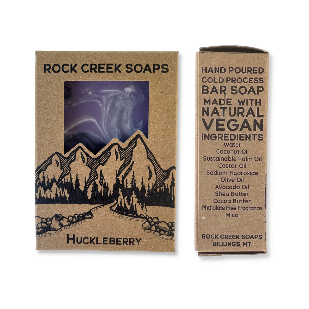 Rock Creek Soaps Huckleberry Scent In Plastic Free, Kraft Cardboard Packaging. Front And Side Views, Showing Features And Ingredients.