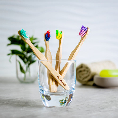 OLA Bamboo Toothbrushes For Kids. Four In Drinking Glass. 